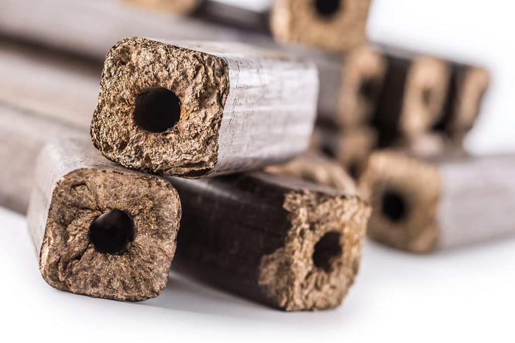 wooden-pressed-briquettes-pini-kay-from-biomass-white-isolated-background